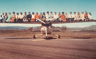 People Lined up on the Wing of a Plane
